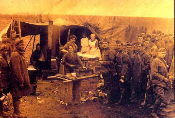 Salvation Army workers serving fresh doughnuts to American doughboys just in from the Meuse-Argonne front, October 12, 1918